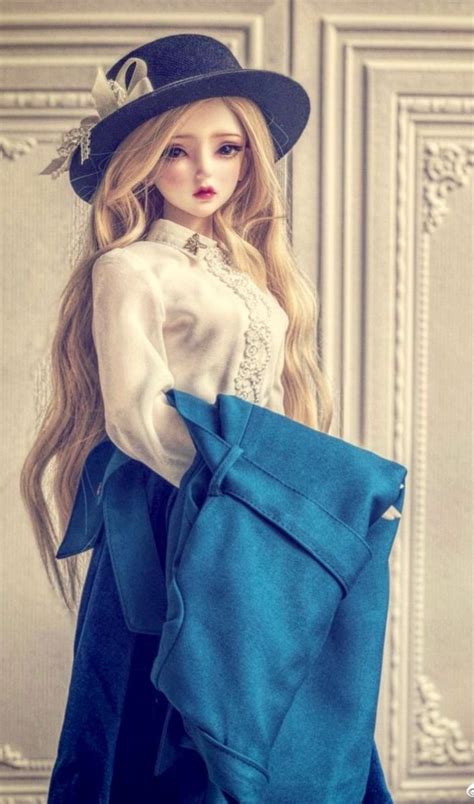 a doll is holding a blue purse