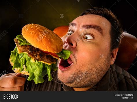 Fat Guy Eating Burger : Hungry Fat Man Eating Burger Side View ...