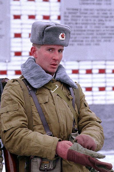 Soviet Soldier wearing his government issued Ushanka hat with ear flaps ...