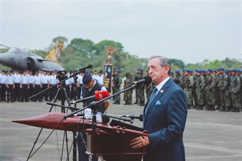 Serious general in suit giving speech behind army during celebration ...