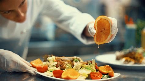 Chef placing finishing touches on a meal. - The Wellington Agency