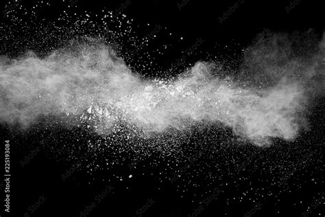 Bizarre forms of white powder explosion cloud against black background ...