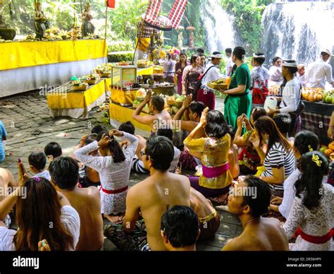 Bali Hinduism, devout people praying in front of shrine in Taman Beji Griya Waterfall, Kabupaten ...