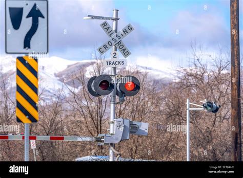 Grade crossing signal with red light gate and crossbuck at railroad crossing Stock Photo - Alamy