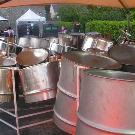 Pictures of steelpans : (a) Steelpans of a typical steelband. (b ...