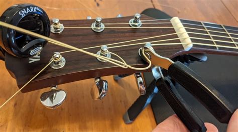 How to Restring an Acoustic Guitar - step by step guide on changing acoustic guitar strings ...