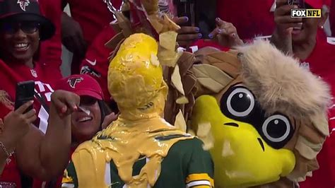 Green Bay Packers fan has cheese sauce poured over his head by Atlanta Falcons mascot after ...