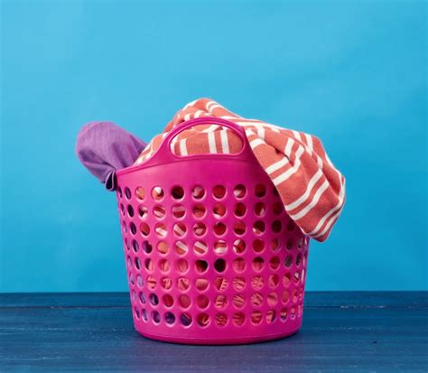 Premium Photo | Plastic pink basket with dirty clothes