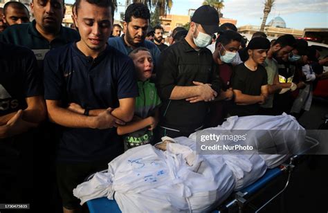 People mourn by the body of Hamas commander Ayman Nofal during his ...