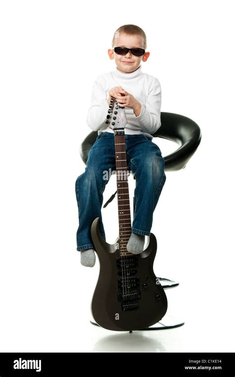 Cute little boy holding a guitar isolated on white Stock Photo - Alamy