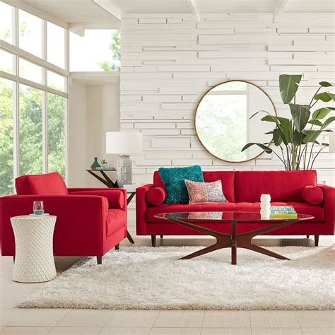 a living room with red couches and white rugs on the floor in front of ...