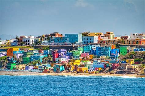 Bright Colorful Houses Line The Hills Overlooking The Beach In San Juan ...