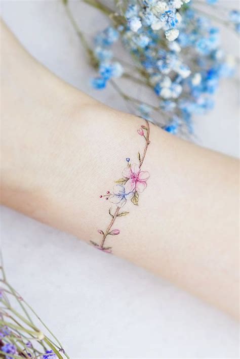 62 Delicate Wrist Tattoos For Your Upcoming Ink Session | Flower wrist tattoos, Wrist bracelet ...