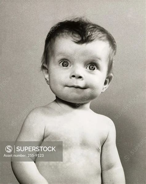 Close-up of a baby looking surprised - SuperStock