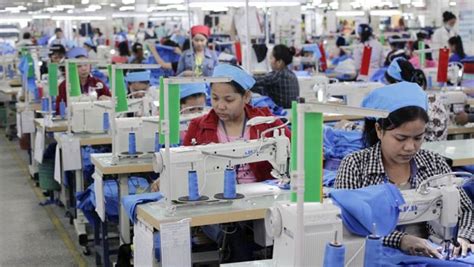 Garment workers sew clothes at Grand Twins International Factory ...