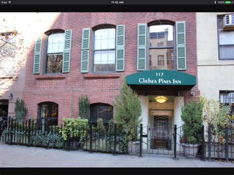 an apartment building with green shutters on the front