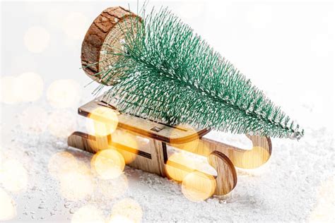Silver Christmas tree with snow on a wooden background - Creative ...