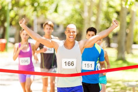 Male Marathon Runner Crossing Finishing Line - The Giving Crowd