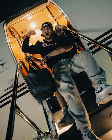 a man sitting on the steps of an airplane with his mouth open and hands ...