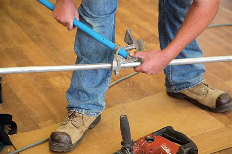 Electrician Using A Pipe Bender Photograph by Jim West