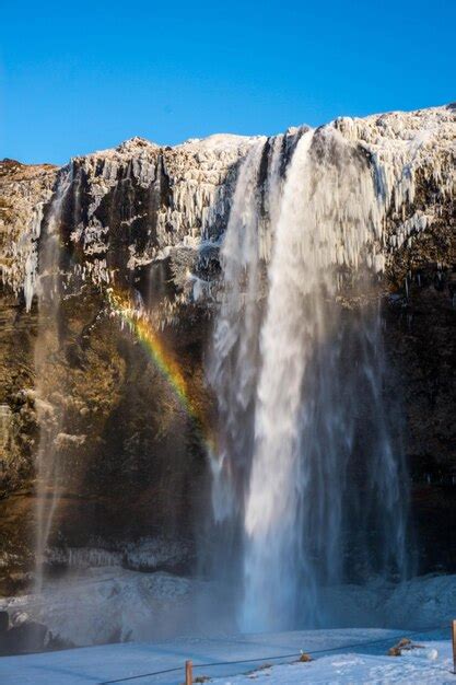 Premium Photo | Rainbow at seljalandsfoss against clear blue sky