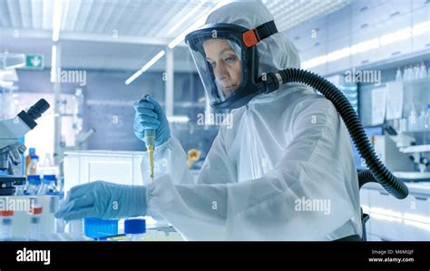 Medical Virology Research Scientist Works in a Hazmat Suit with Mask ...