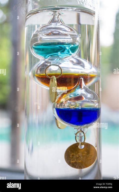 Floating glass liquid Galileo thermometer Stock Photo - Alamy