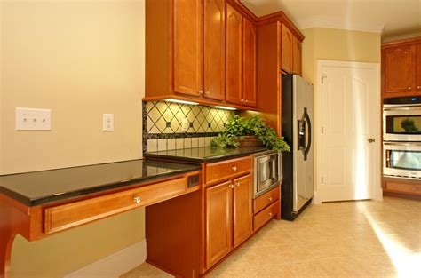 This built-in desk incorporates a large drawer and electrical plug outlet for storage and ease ...