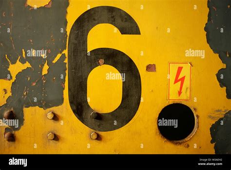 Black number 6 on yellow painted steel surface Stock Photo - Alamy