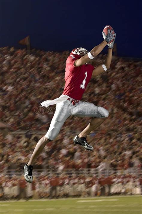 Football Wide Receiver Making a Leaping Catch. African American ...