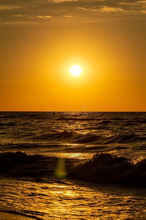 Gold sunrise on the beach stock photo. Image of evening - 252829148