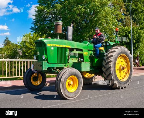 French farmer driving old restored John Deere 4020 diesel tractor on ...