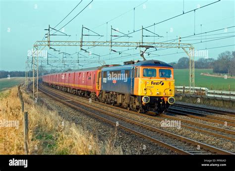 A class 87 AC electric locomotive number 87028 ‘Lord President’ with class 325 mail units in tow ...