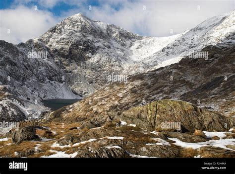 View of the snow covered summit of Snowdon in Snowdonia National Park, Wales, UK from the Pyg ...