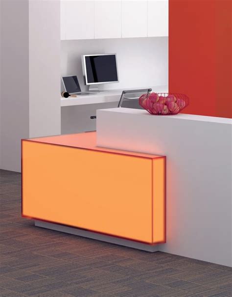 an orange and white desk with a computer on it