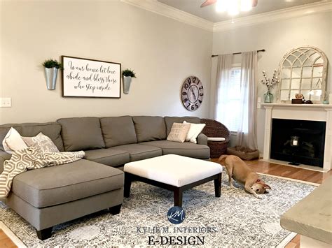 Sherwin Williams Agreeable Gray in living room with gray sectional couch, area rug, fireplace ...