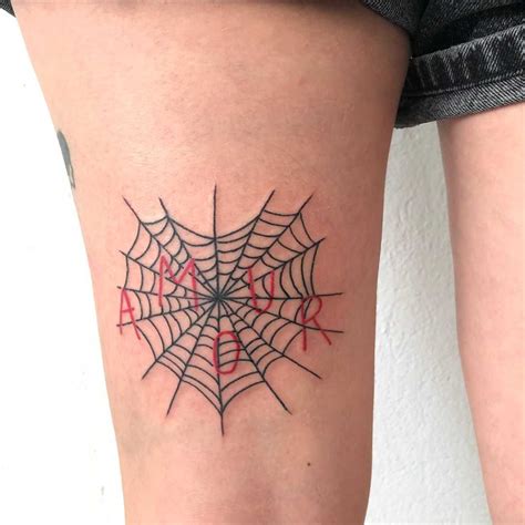 A heart-shaped spider web and a word ‘amour’ inked on the left thigh by ...