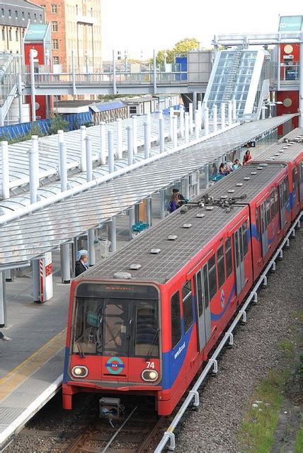 A Docklands Light Railway train departs Custom House station heading ...