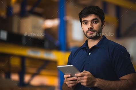 warehouse worker using bar code scanner to analyze newly arrived goods for further placement ...