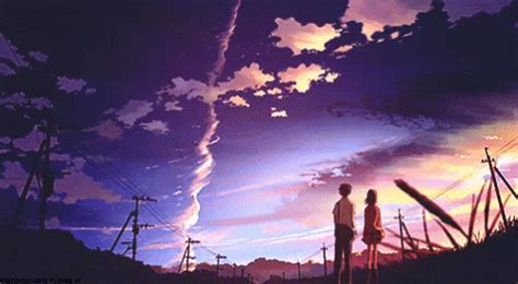 two people standing in front of a purple sky with clouds and telephone ...