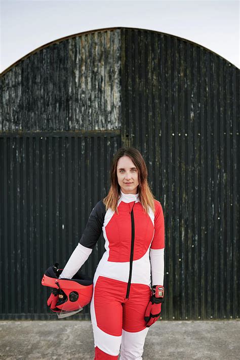 Young Female Skydiver Posing In A Black Wall With Helmet And Gloves ...