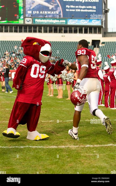 Temple Owls mascot, Hooter, gets a fist bump from Temple Owls defensive ...