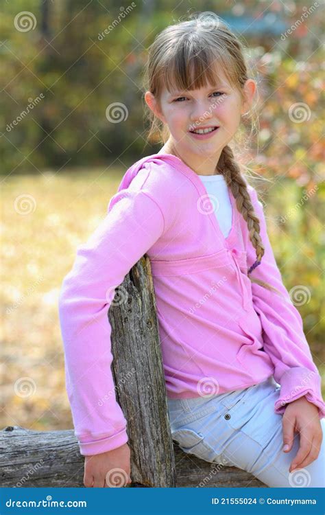 Young Girl Sitting On Fence Stock Images - Image: 21555024