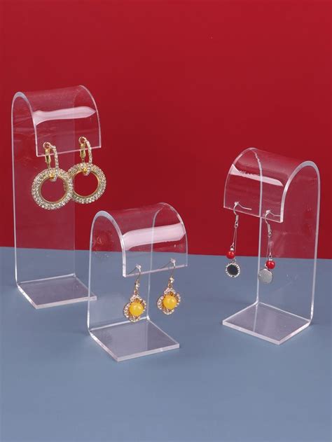 three clear acrylic jewelry displays with earrings