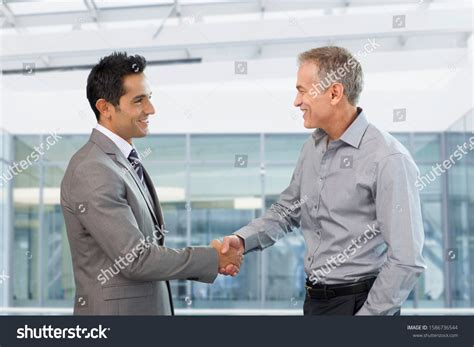 Two Businessmen Shaking Hands Office Stock Photo (Edit Now) 1586736544