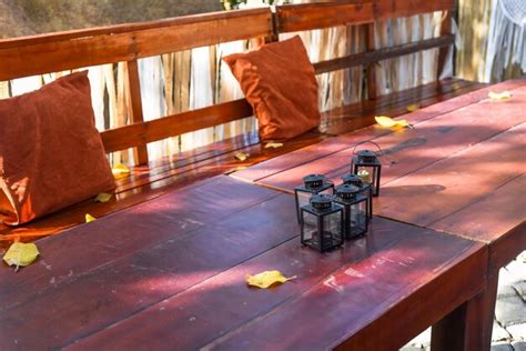 Premium Photo | Wooden table and bench for celebrating a holiday with autumn colors decor ...