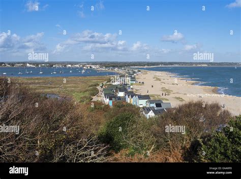 Beach huts lining the sandy beach at Hengistbury Head nature reserve in Dorset, England, UK ...