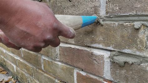 Mortar Crack Repair. Adding mortar to brick. Tuckpointing brickwork ...