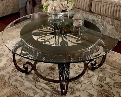 Clear Round Glass Top Coffee Table With Ornate Brown Base Placed In A ...