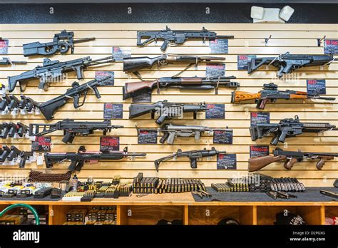 A large variety of guns, rifles, and weapons at a gun store Stock Photo - Alamy